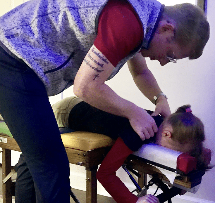 Chiropractor providing non-invasive pain relief treatment to a patient, highlighting natural pain relief methods